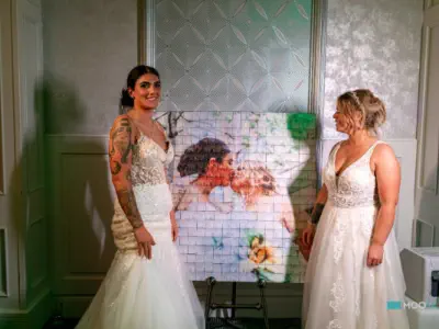 brides with a completed mosaic wall
